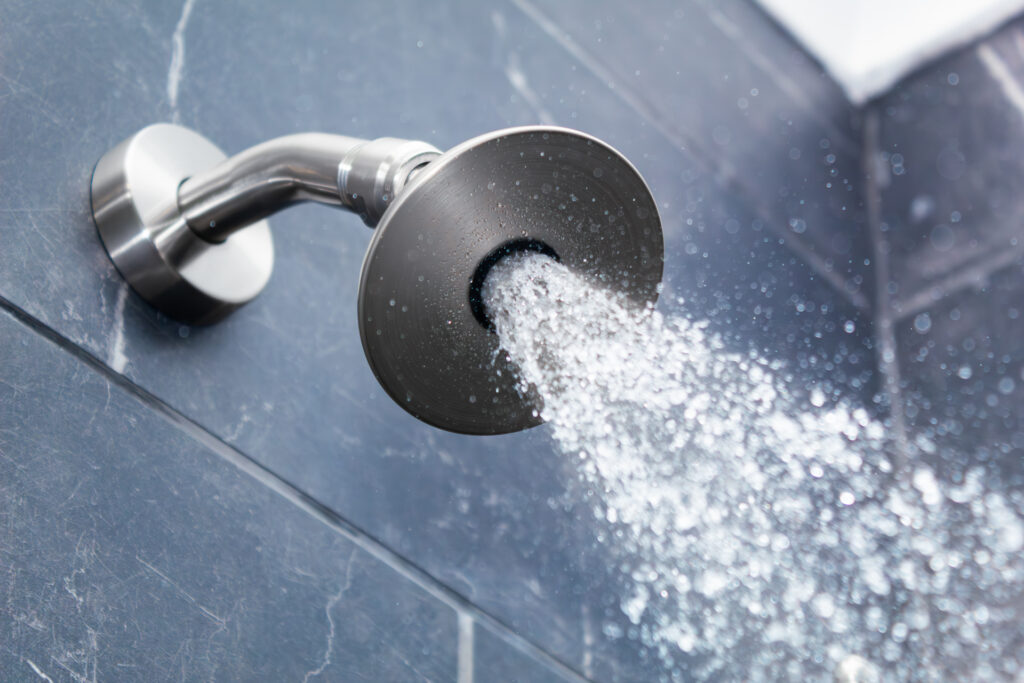 Low flow shower head spraying a strong jet of water