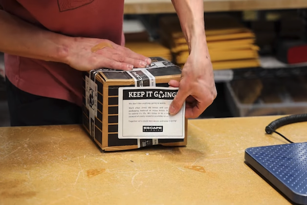 Reused packaging box with a "Keep It Going" label. Photo credit: Escape Climbing, LLC