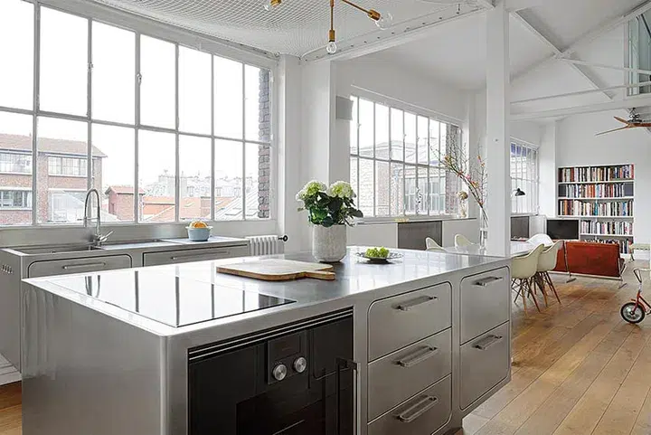 Kitchen with stainless steel fixtures and countertops
