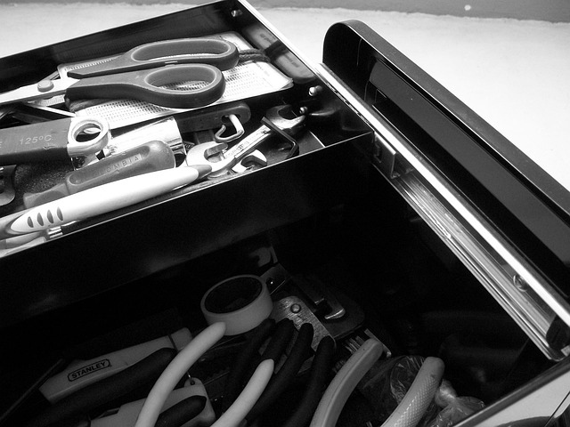 Black toolbox full of various tools