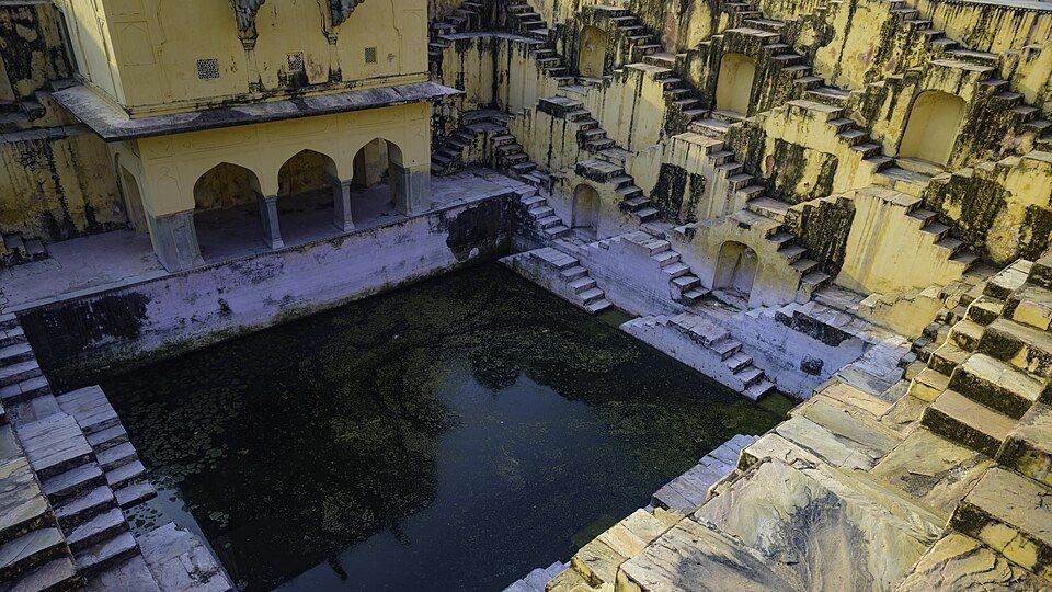 Amer Village stepwell Panna Meena ka Kund stepwell in the town of Amer, Jaipur, India. Resized and cropped from photo by Bobinson on Wikimedia Commons, https://commons.wikimedia.org/wiki/File:Stepwell_in_Amer_Village.jpg